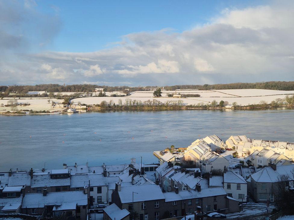 A view of houses and a river covered in snow at Bryn Y Felin in Y Felinheli