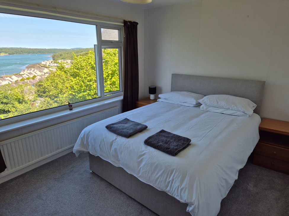 A bedroom with a bed and bedside table at Bryn Y Felin in Y Felinheli