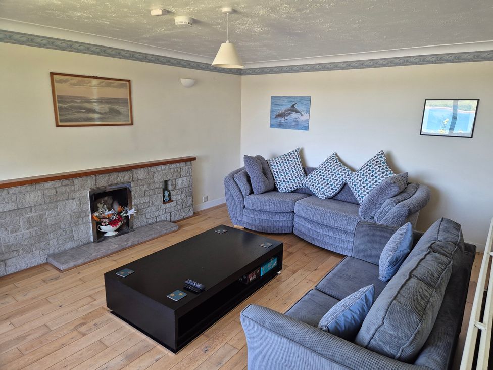 A living room with a sofa and coffee table at Bryn Y Felin in Y Felinheli