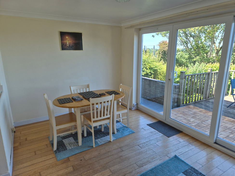 A dining room with a table and chairs at Bryn Y Felin in Y Felinheli