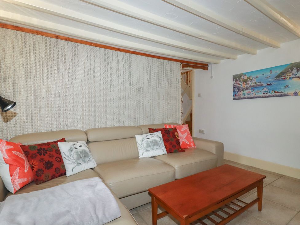 A living room with a sofa and coffee table at Plenteth in Truro