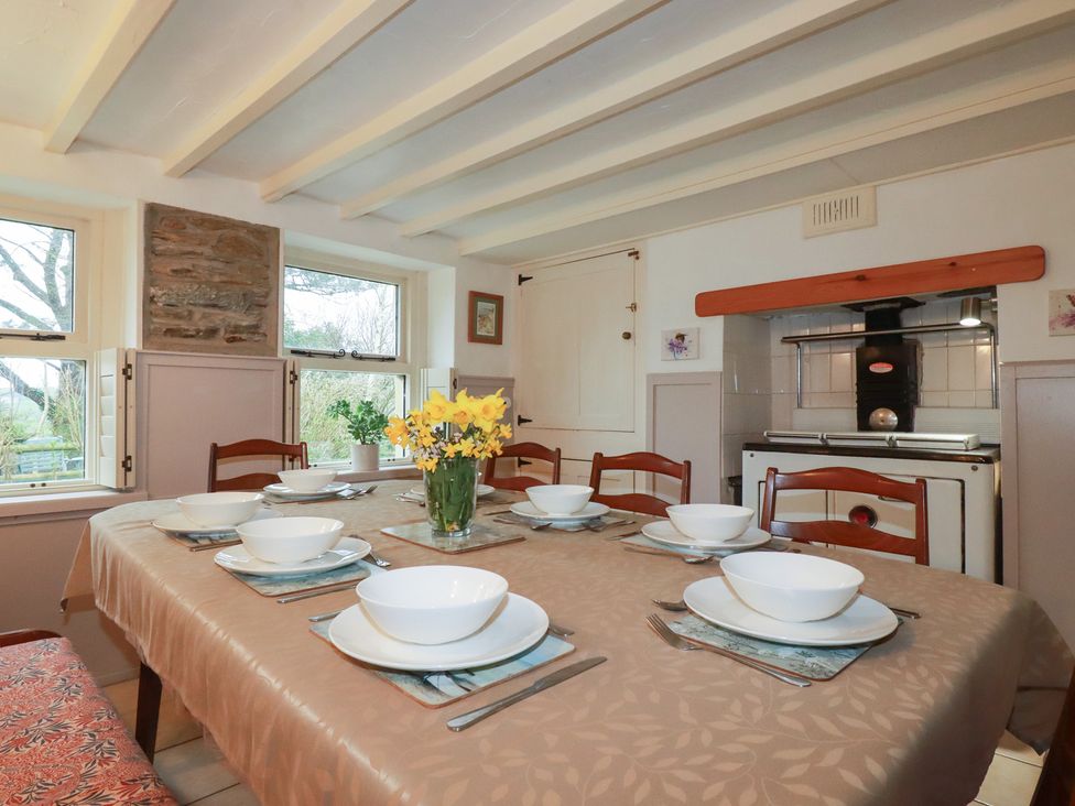 A dining room with a table set for meals at Plenteth in Truro