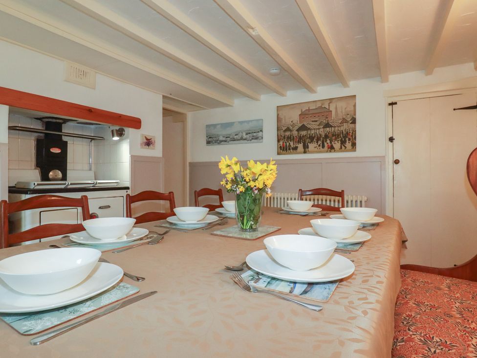 A dining room with a table set for meals at Plenteth in Truro