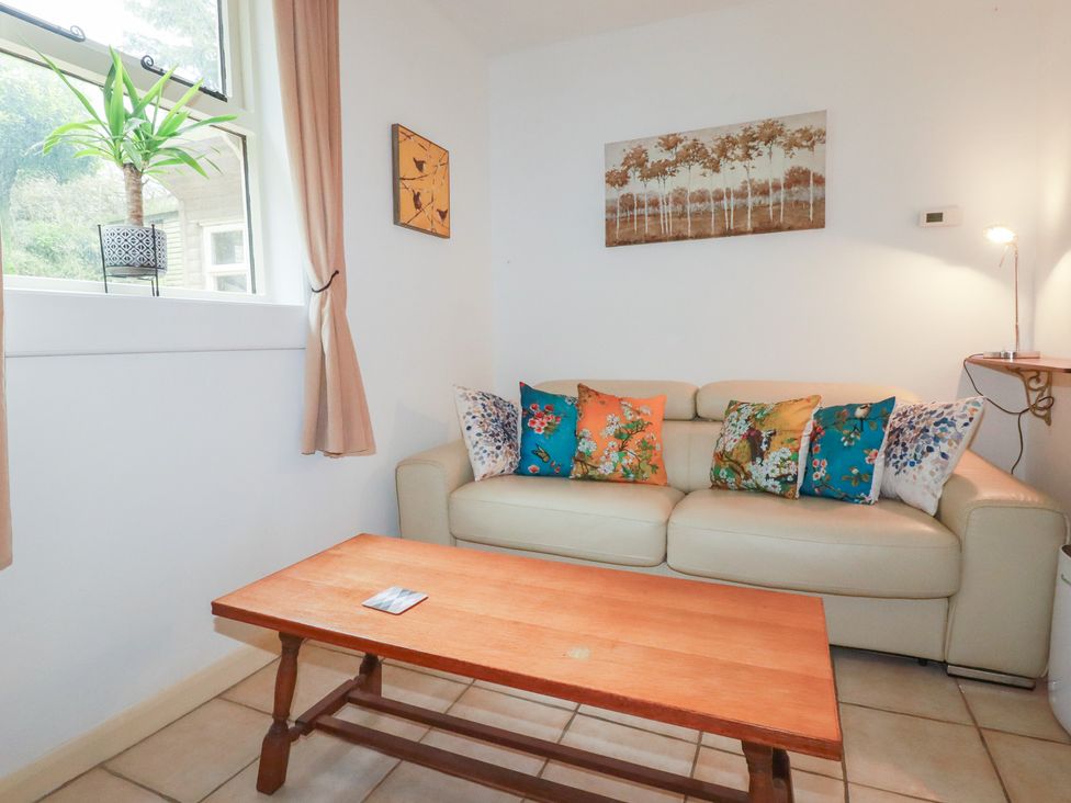 A living room with a couch and coffee table at Plenteth in Truro