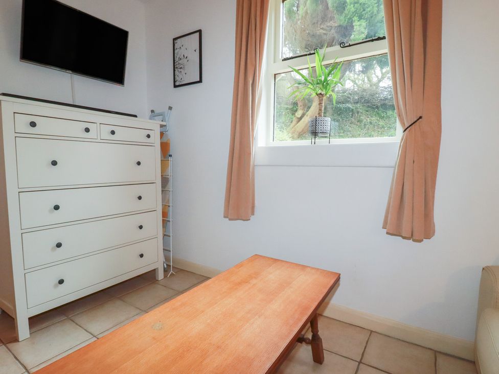 A living room with a dresser and television at Plenteth in Truro