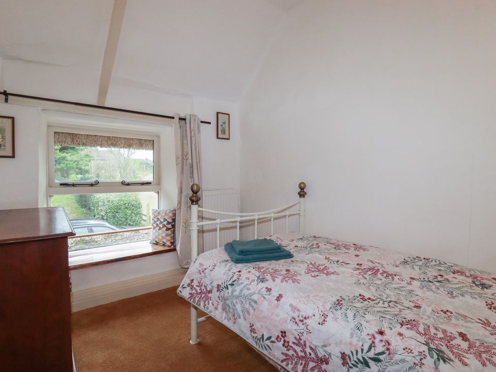 A bedroom with a bed and window at Plenteth in Truro