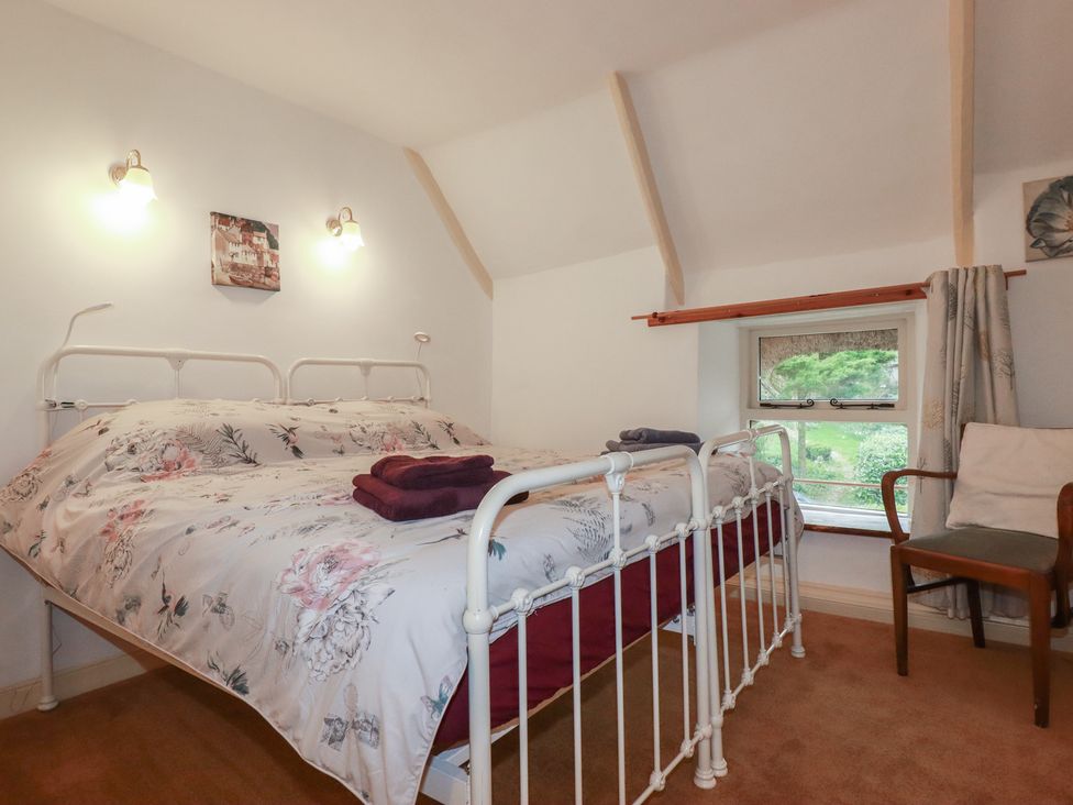 A bedroom with a bed and window at Plenteth in Truro