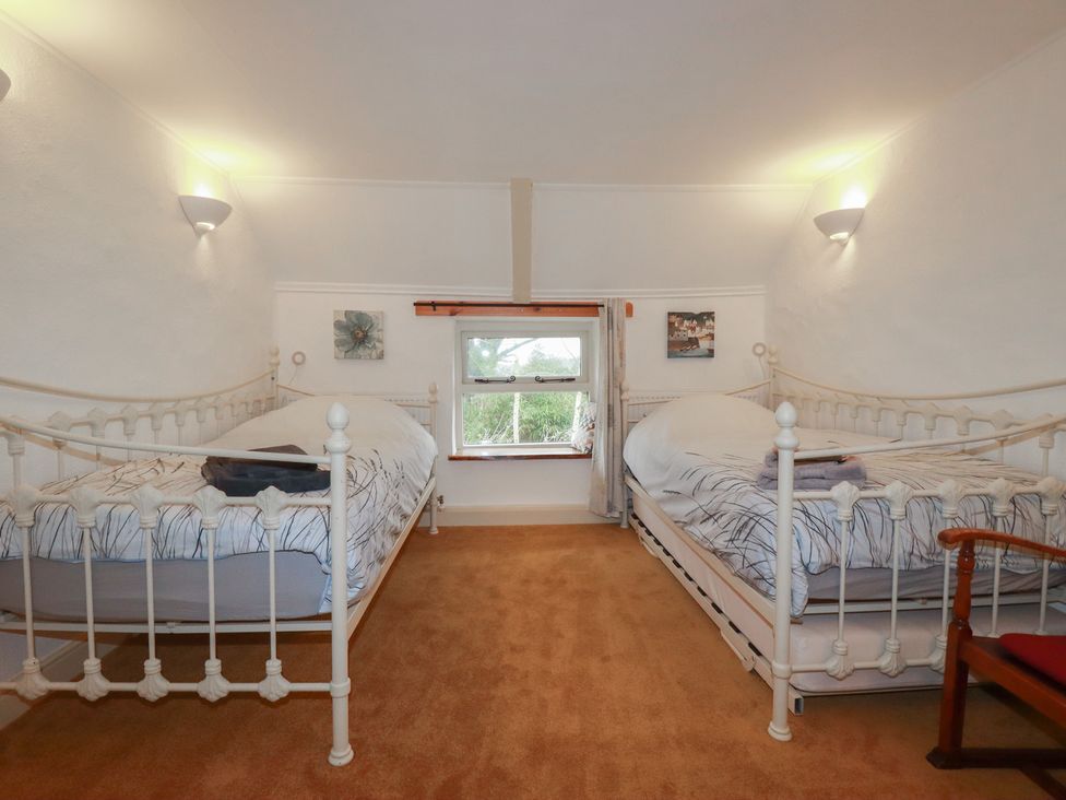 A bedroom with two beds and a window at Plenteth, Truro