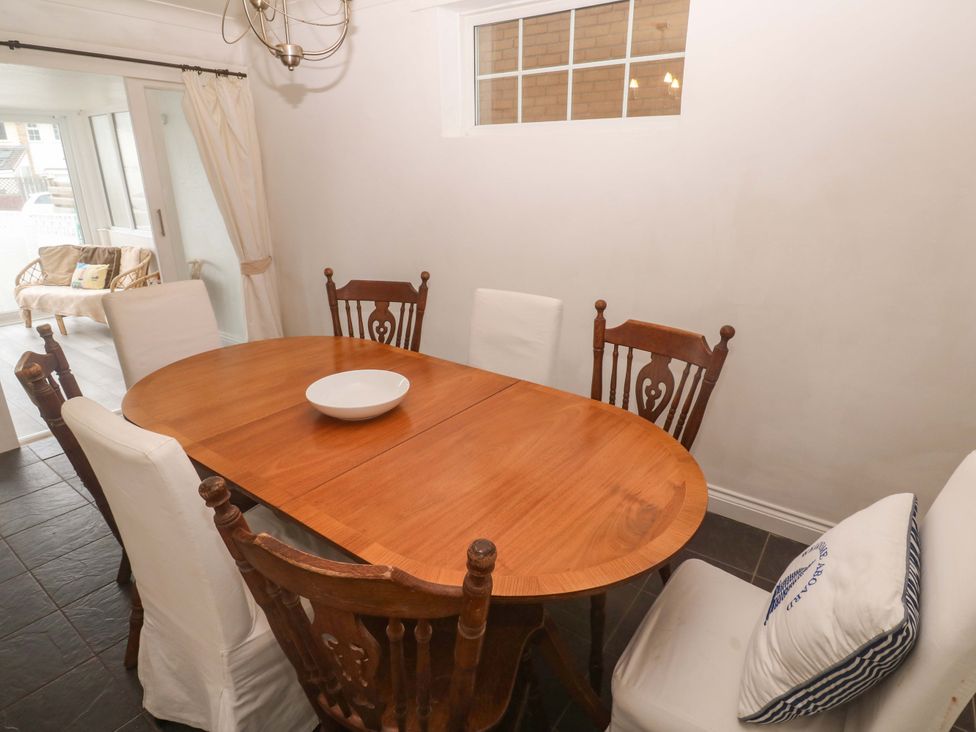 A dining room with a wooden table and chairs at 16 Forth An Nance in Redruth