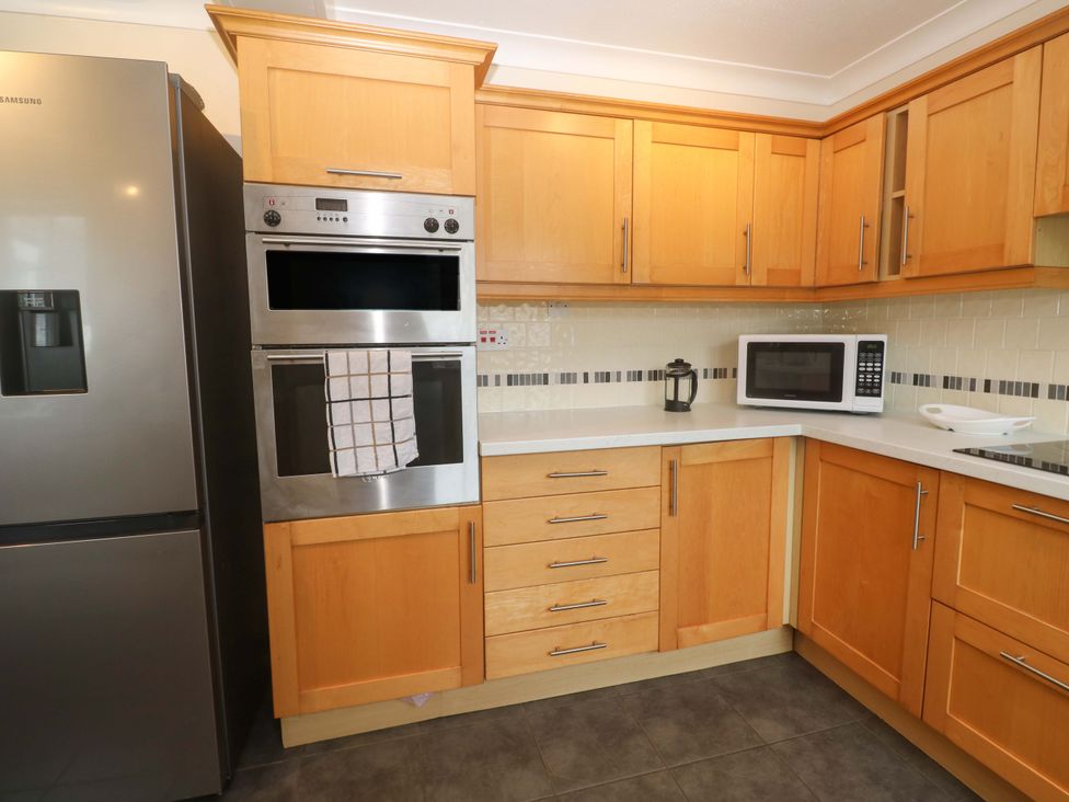 A kitchen with refrigerator, oven, microwave, and cabinets at 16 Forth An Nance Redruth