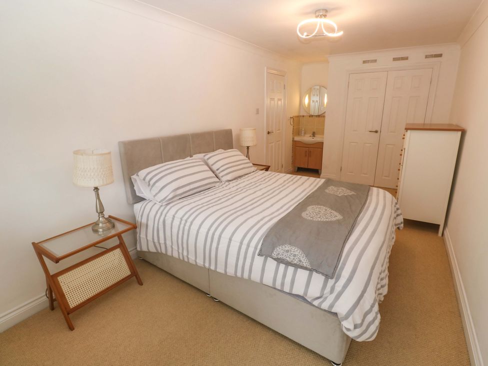 A bedroom with a bed and bedside table at 16 Forth An Nance in Redruth