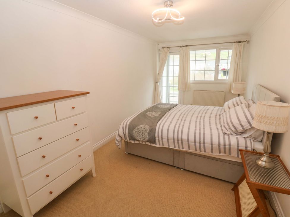 A bedroom with a bed and dresser at 16 Forth An Nance Redruth