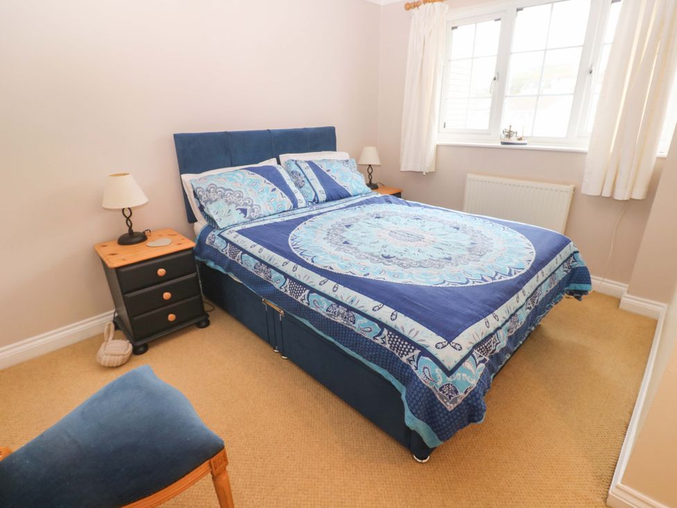 A bedroom with a bed and bedside lamp at 16 Forth An Nance in Redruth