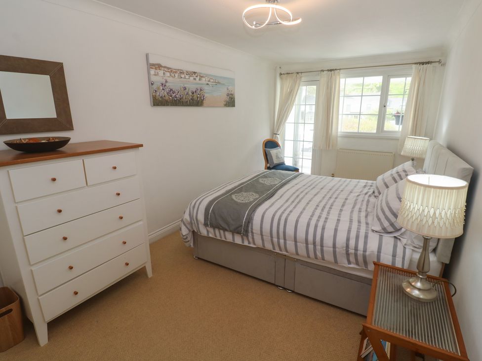 A bedroom with a bed and dresser at 16 Forth An Nance in Portreath