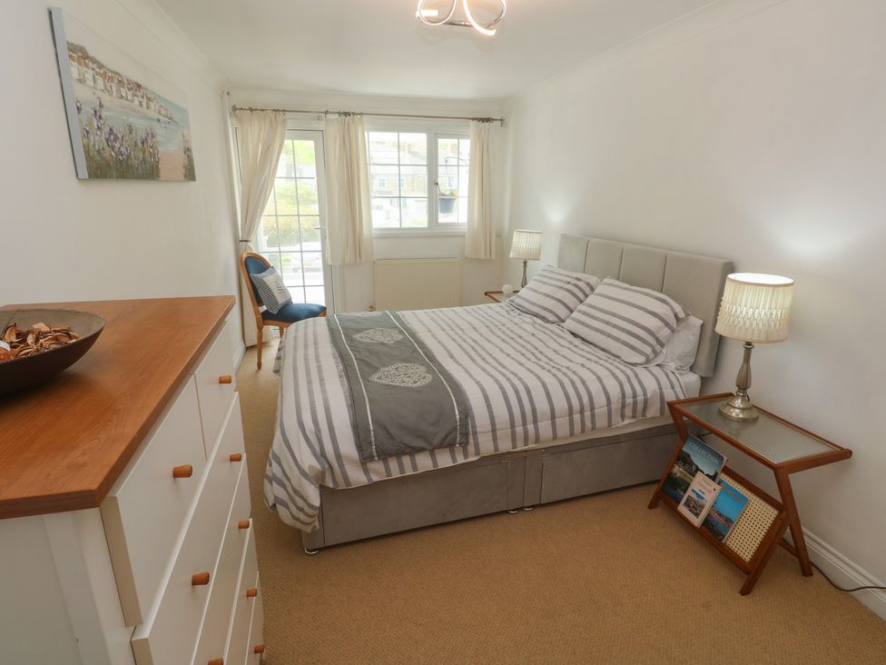 A bedroom with a bed and dressing table at 16 Forth An Nance in Portreath