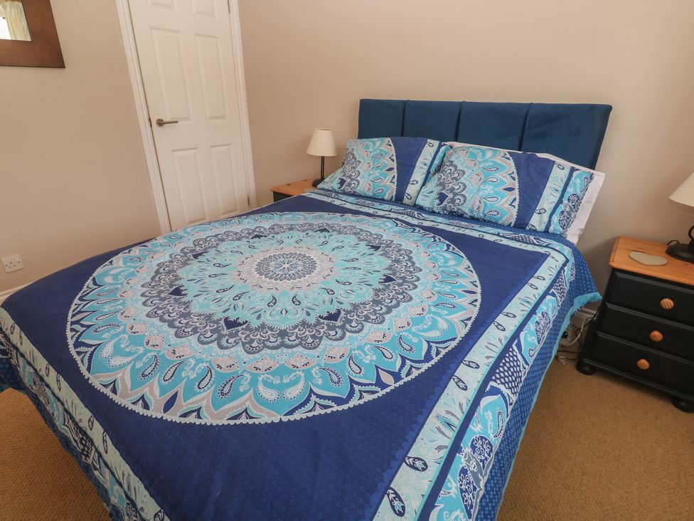 A bedroom with a bed and nightstand at 16 Forth An Nance in Portreath