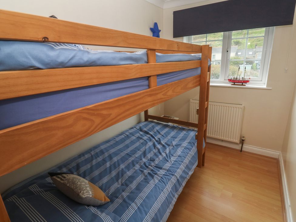 A bedroom with a bunk bed and window at 16 Forth An Nance Portreath