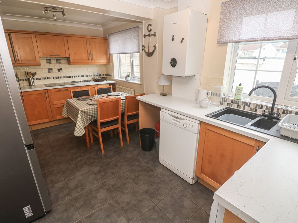 A kitchen with a dining table and chairs at 16 Forth An Nance in Portreath