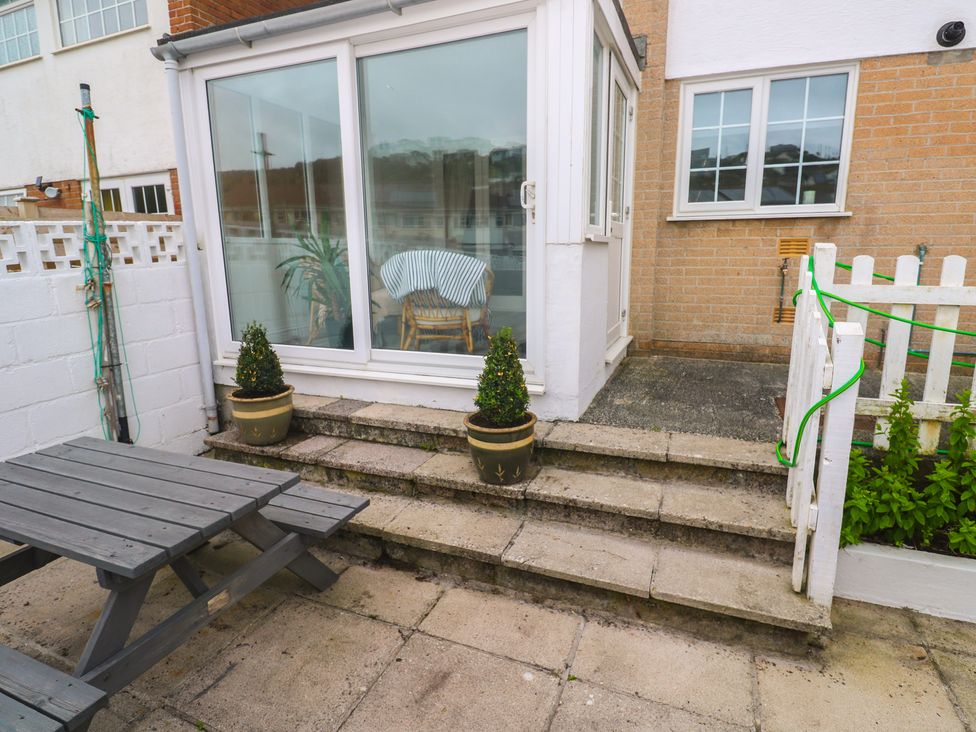 A patio area with a table and steps at 16 Forth An Nance, Portreath