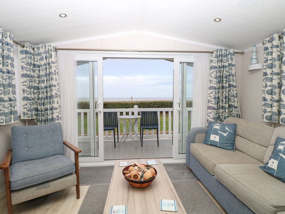 A living room with a sofa and coffee table at Caravan in Great Yarmouth