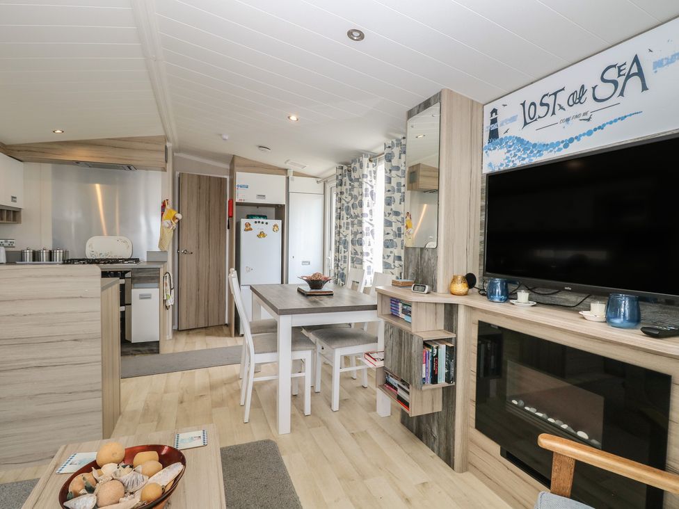 A living room with kitchen and dining table at Caravan in Great Yarmouth
