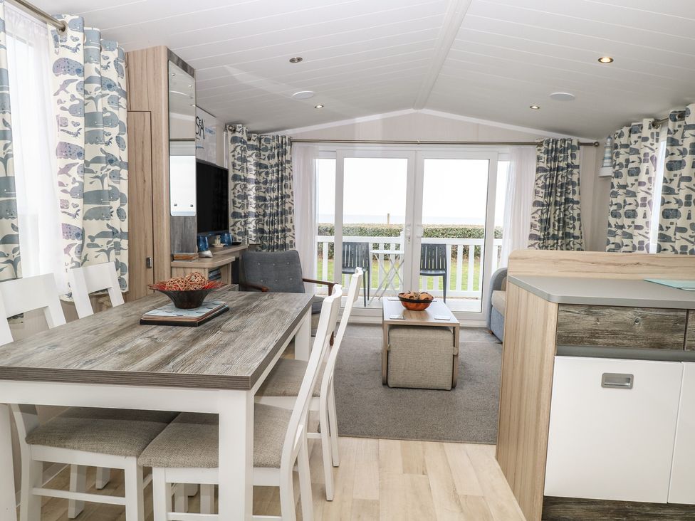 A dining room with a table and chairs at the Caravan in Great Yarmouth