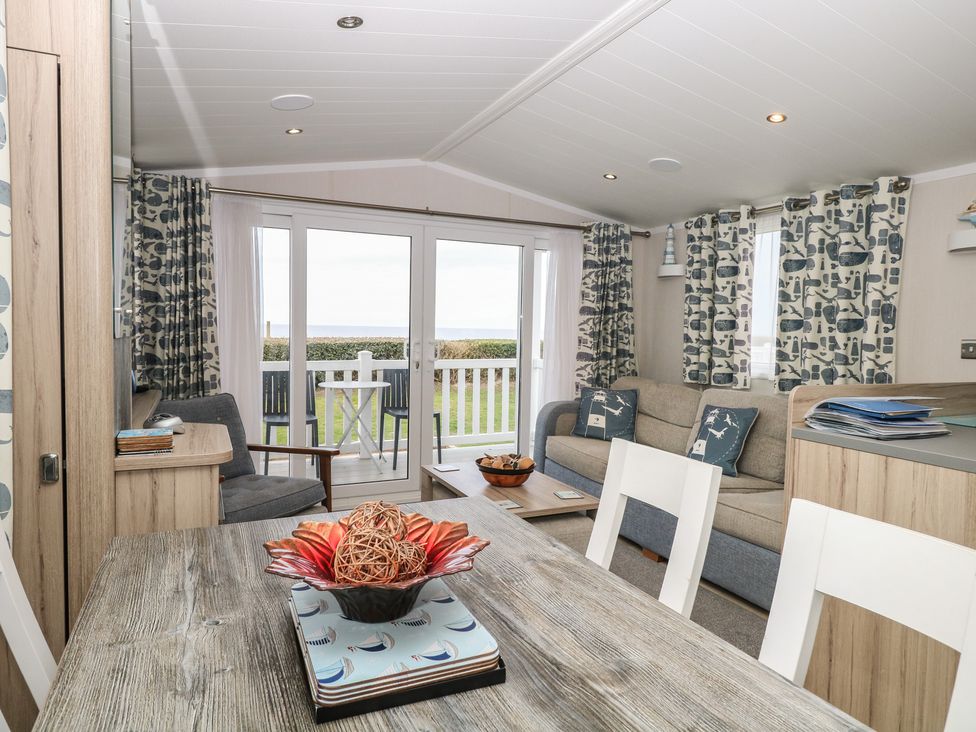 A living room with a sofa and dining area at Caravan in Great Yarmouth