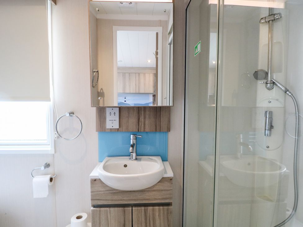 A bathroom with a sink and shower at the Caravan in Great Yarmouth