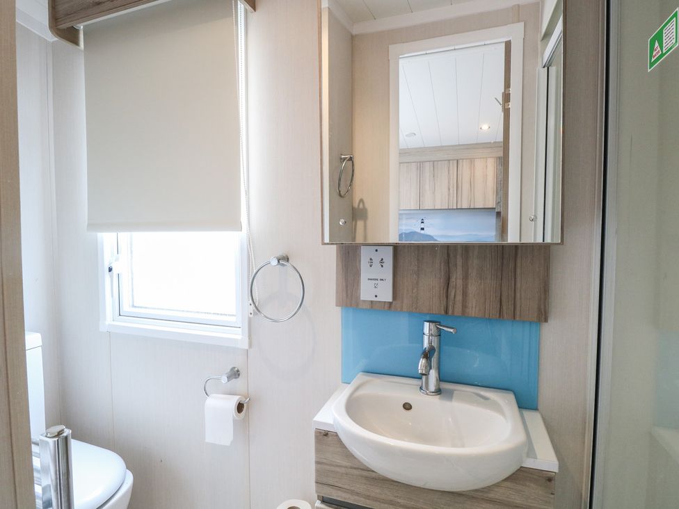 A bathroom with a sink and toilet at Caravan in Great Yarmouth