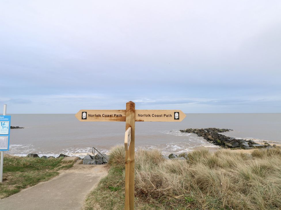 A signpost for Norfolk Coast Path by the beach at Caravan in Great Yarmouth