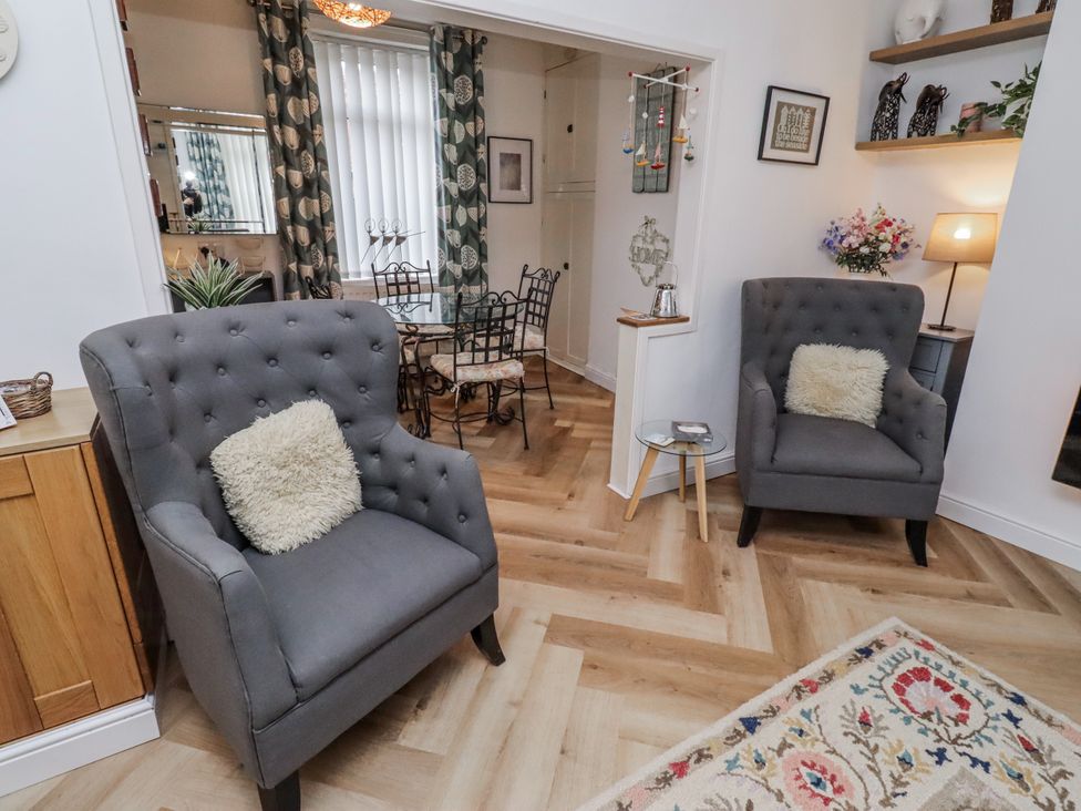 A living room with seating and dining area at 55 Meldon terrace Newbiggin-by-the-Sea