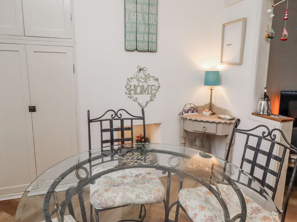 A dining room with a table and chairs at 55 Meldon terrace in Newbiggin-by-the-Sea