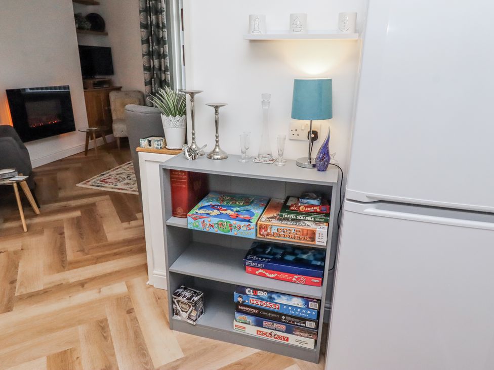 A living room with a bookshelf displaying board games at 55 Meldon terrace Newbiggin-by-the-Sea