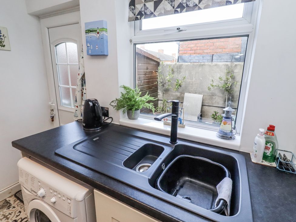 A kitchen with sink and kettle at 55 Meldon terrace in Newbiggin-by-the-Sea