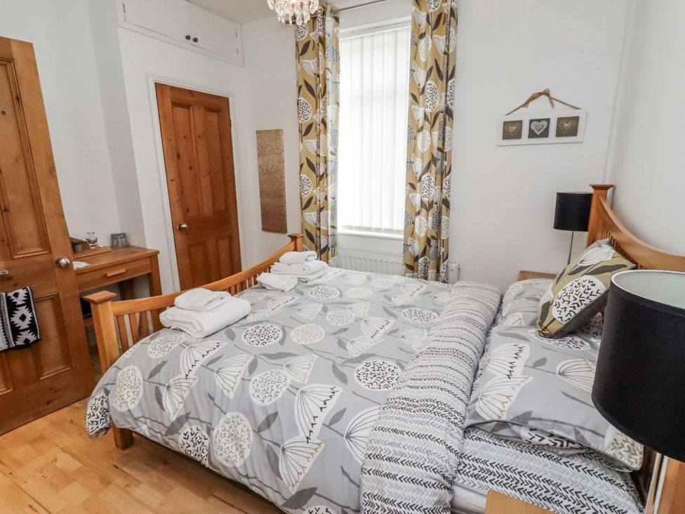 A bedroom with a bed and furniture at 55 Meldon terrace in Newbiggin-by-the-Sea