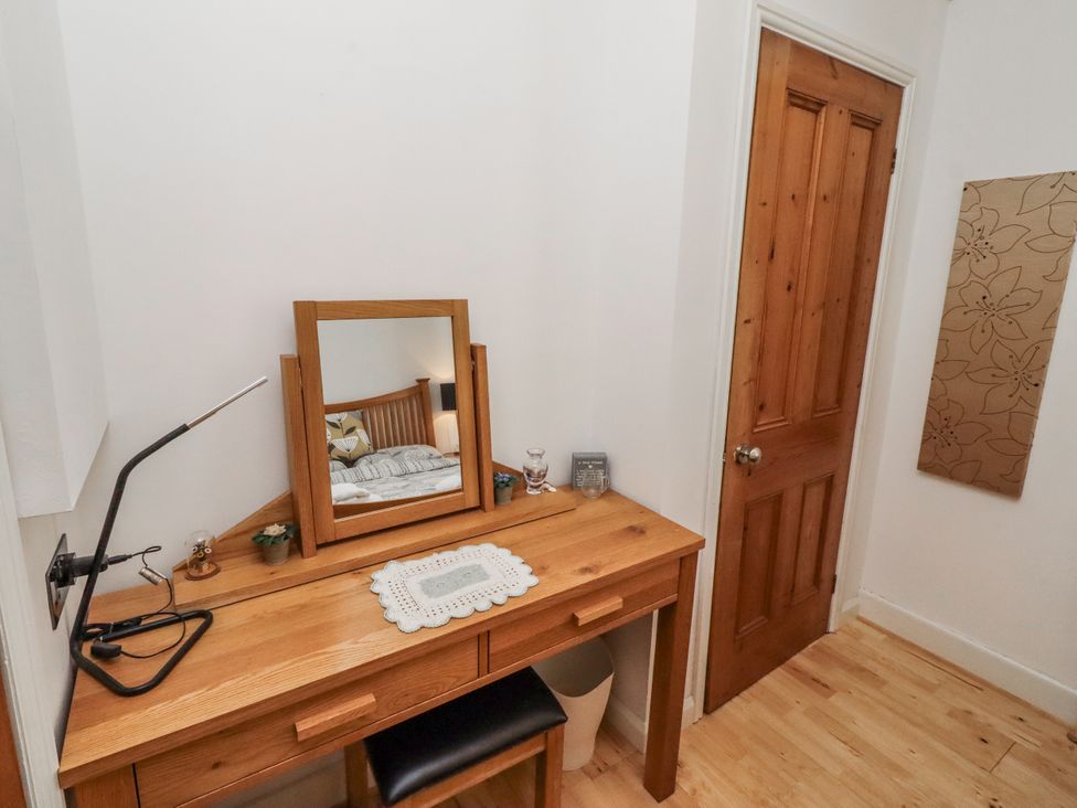 A bedroom with a desk and mirror at 55 Meldon terrace in Newbiggin-by-the-Sea