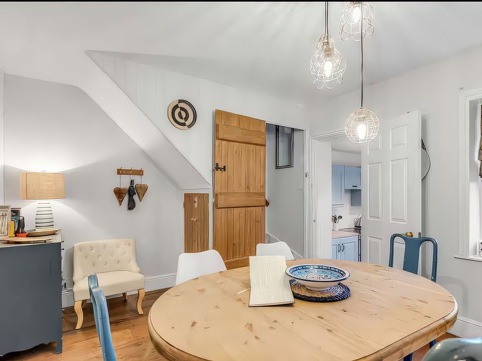 A dining room with a round table and chairs at Bay Tree Cottage in Heacham