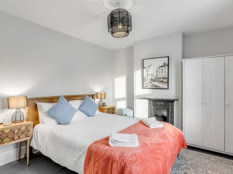 A bedroom with a bed and bedside tables at Bay Tree Cottage in Heacham