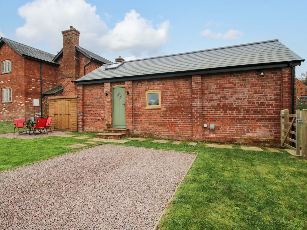 An outdoor area with a brick structure and seating at The Blacksmiths Shop