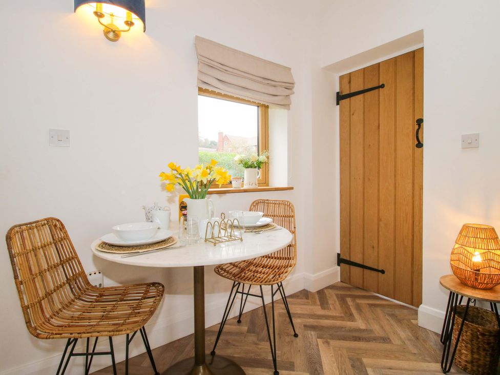A dining room with table and chairs at The Blacksmiths Shop in 