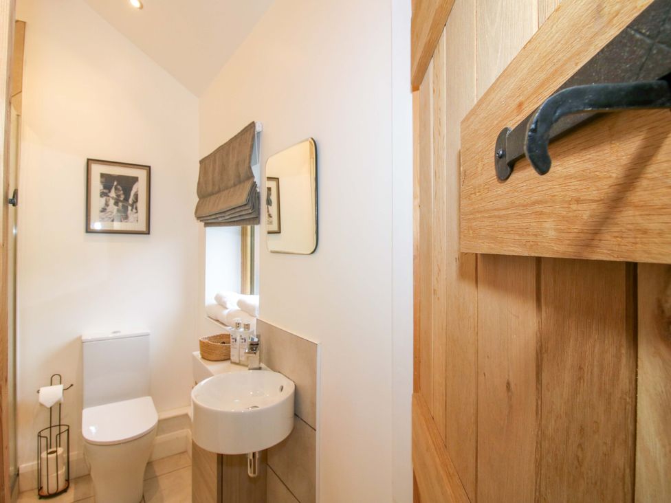 A bathroom with a toilet and sink at The Blacksmiths Shop