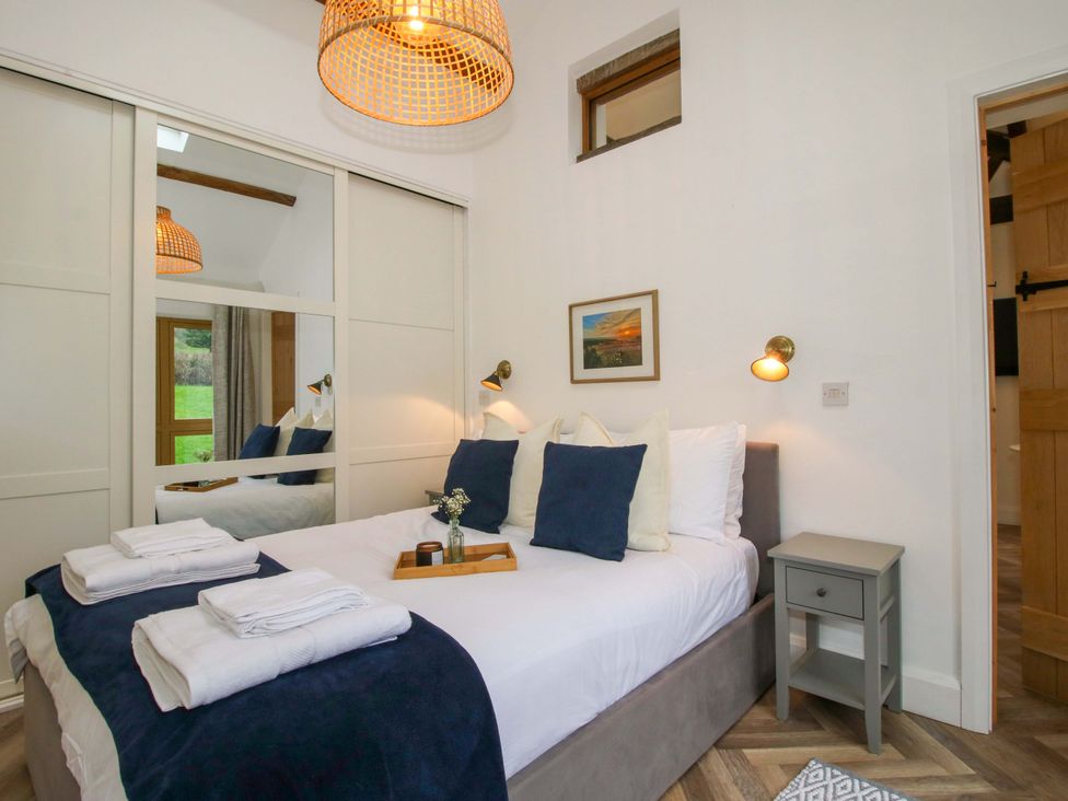 A bedroom with a bed and a bedside table at The Blacksmiths Shop