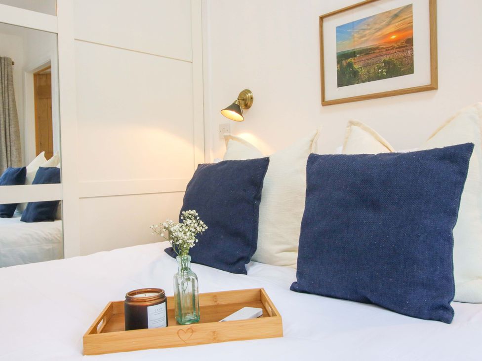 A bedroom with a bed and decorative items at The Blacksmiths Shop