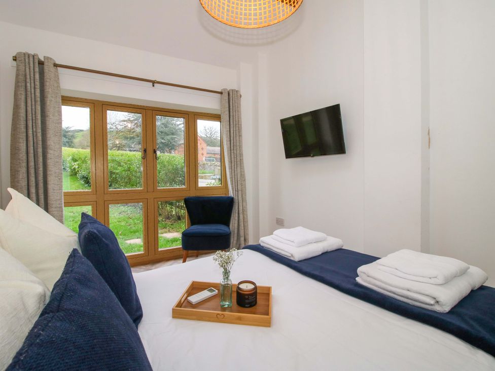 A bedroom with a bed and television at The Blacksmiths Shop