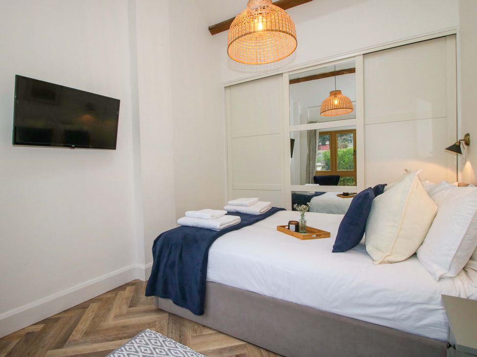 A bedroom with a bed and television at The Blacksmiths Shop in 