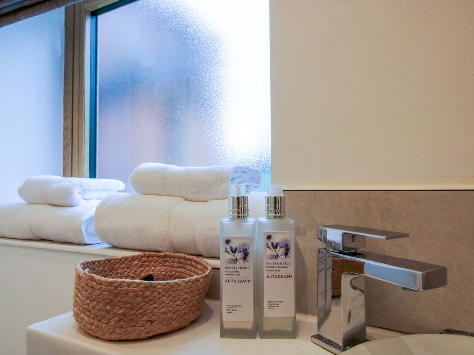 A bathroom with towels and soap dispensers at The Blacksmiths Shop 