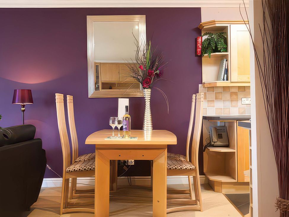 A dining room with a table and chairs at The Gallery in Windermere