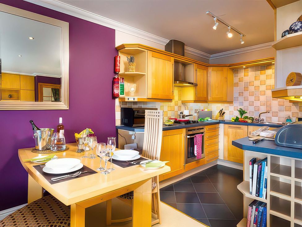 A kitchen with a dining table and stove at The Gallery in Windermere