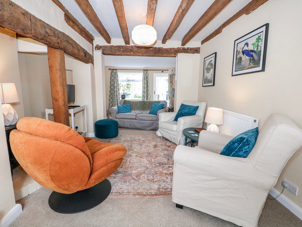 A living room with chairs and a sofa at 7 Chapel Hill Quinc Cottage Lewes