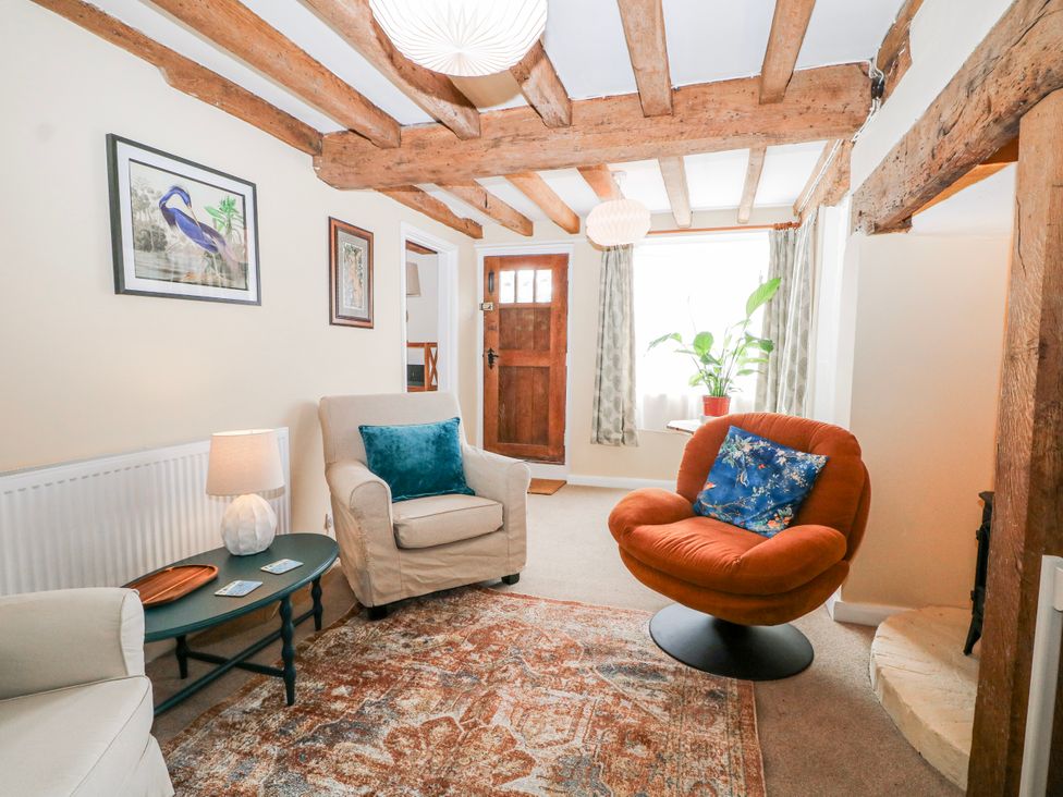 A living room with a sofa and armchair at 7 Chapel Hill Quinc Cottage Lewes